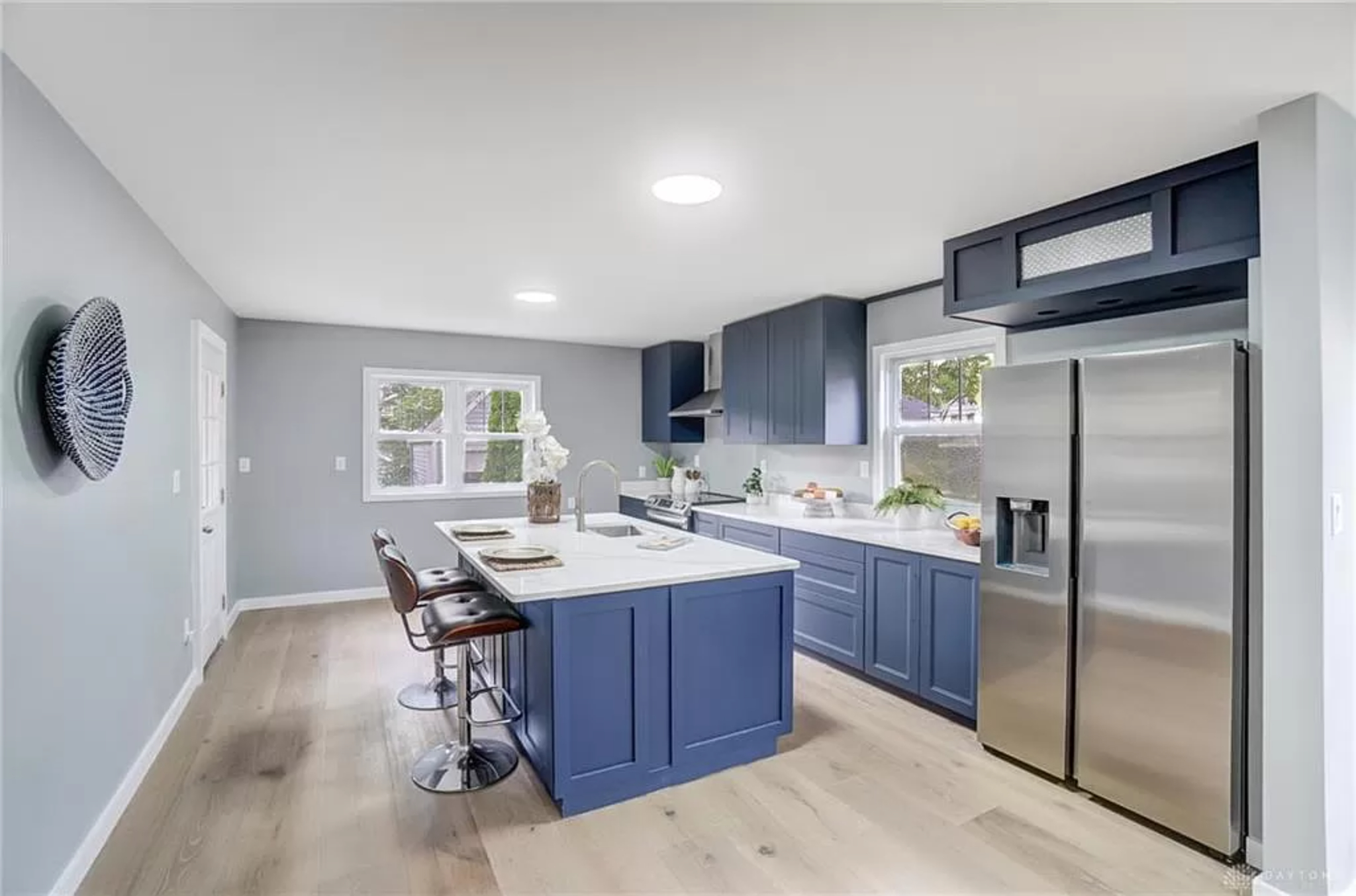 Open kitchen with quartz island and modern cabinetry