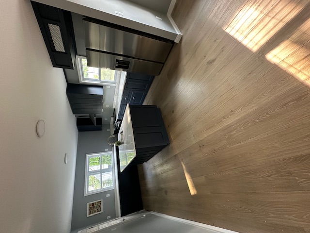 Kitchen wide view showing extended counter run along window wall