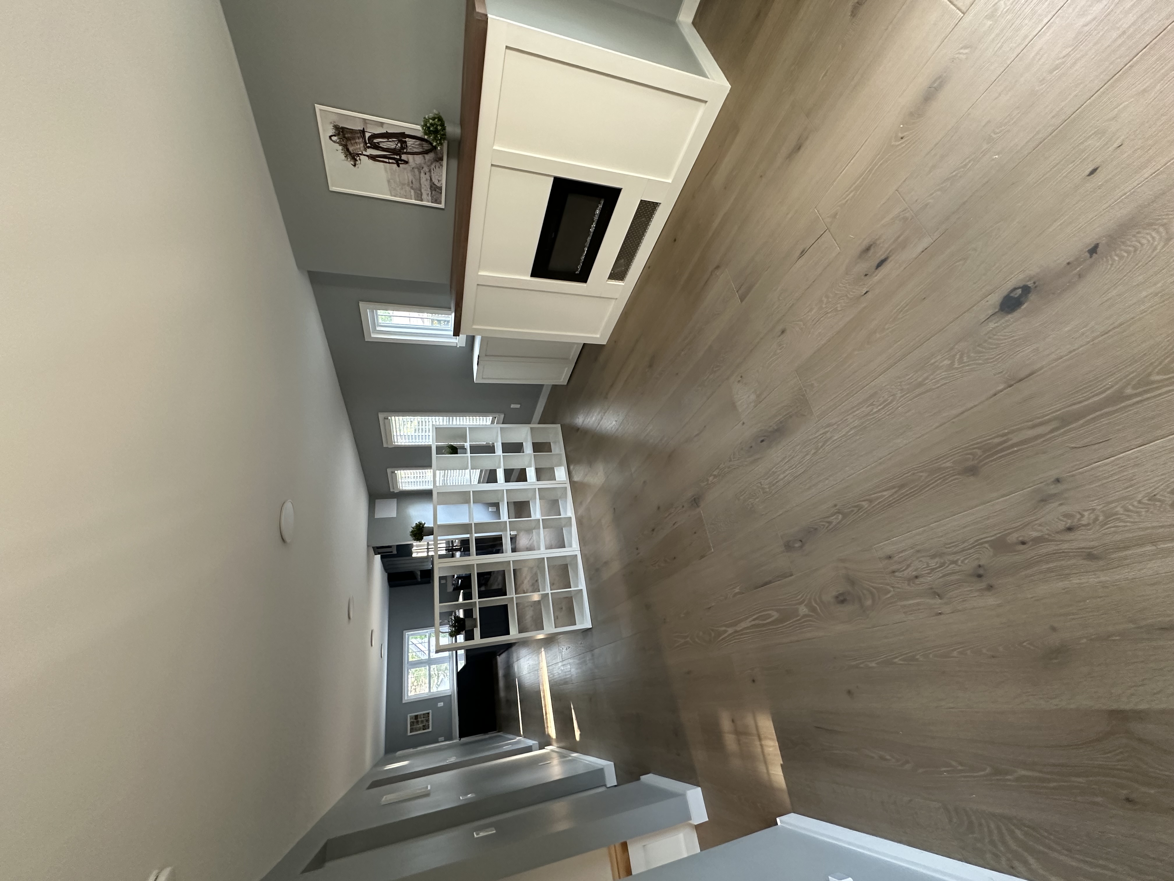 Open living with built-in millwork and bookshelf divider