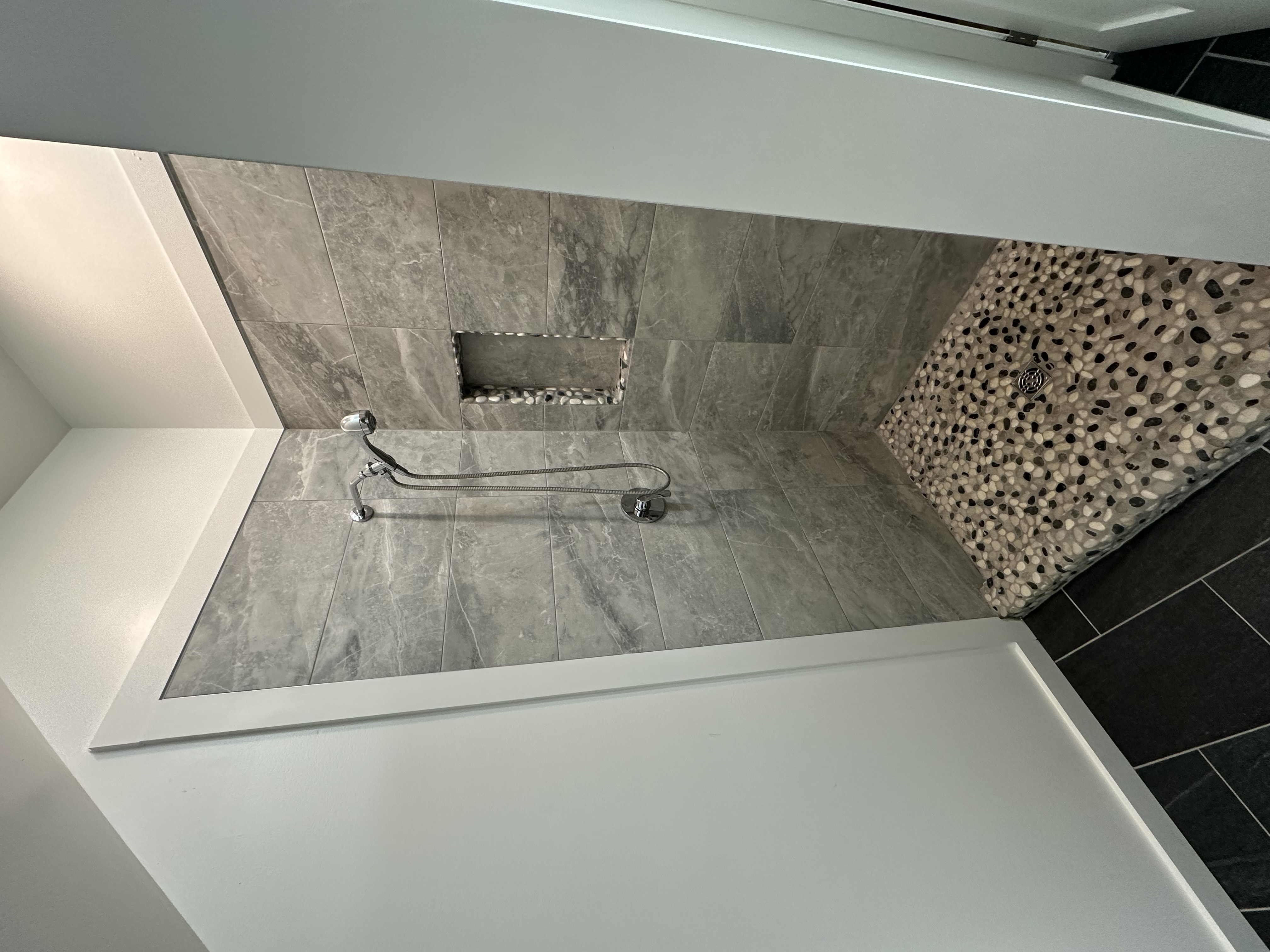 Tile shower with pebble inset floor