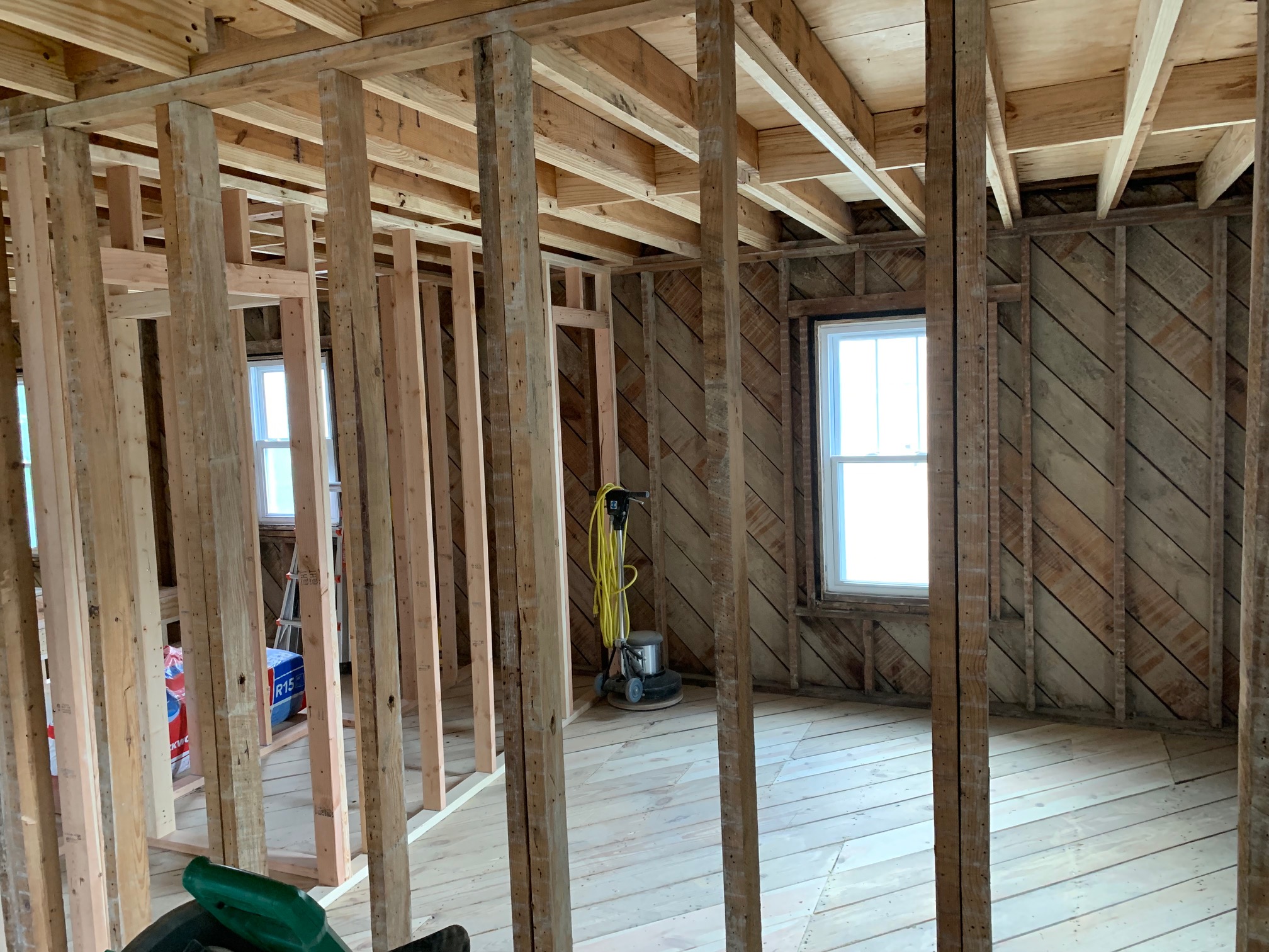 Wall framing exposed with original diagonal sheathing behind
