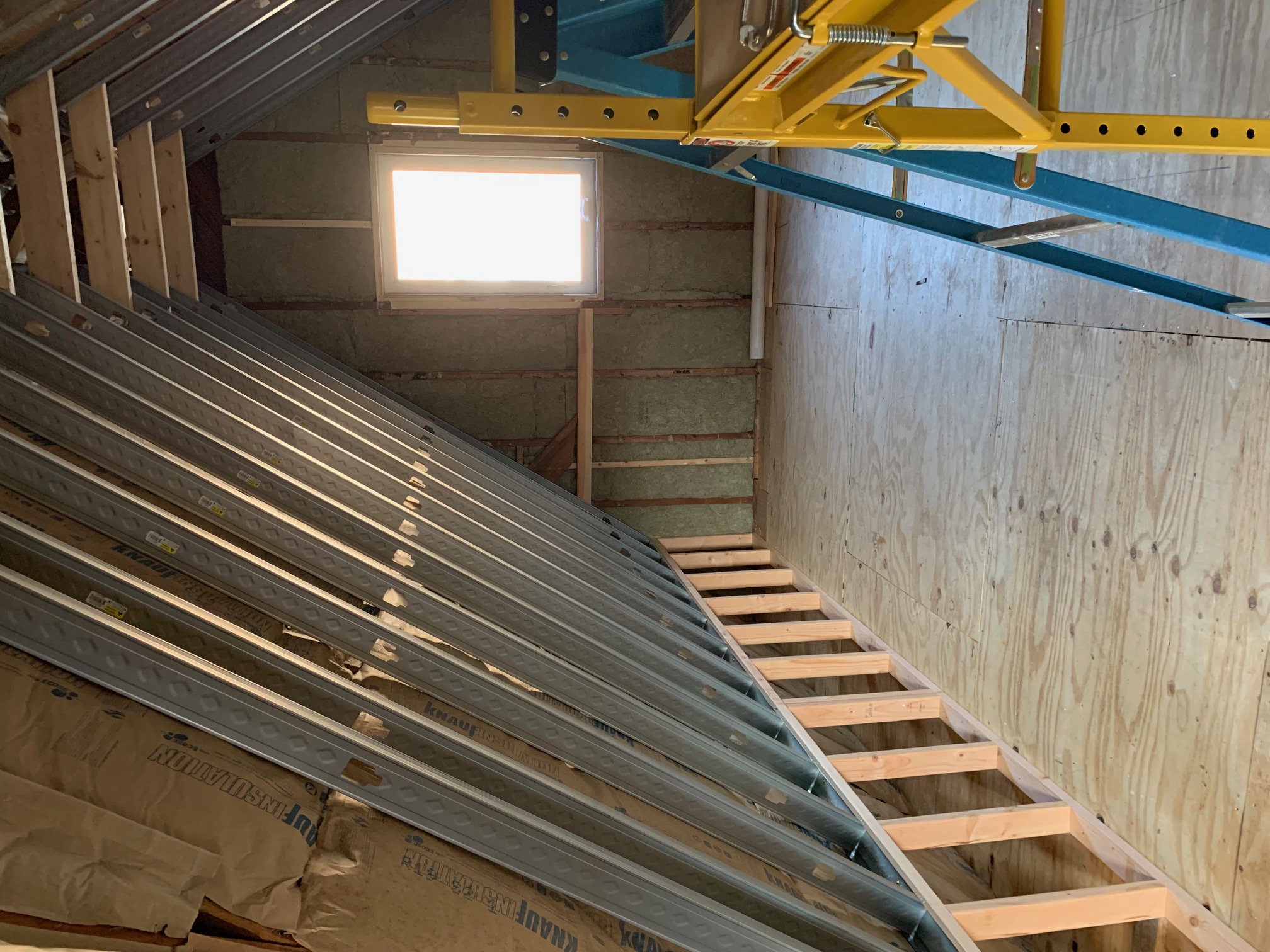 Looking up through layered ceiling framing