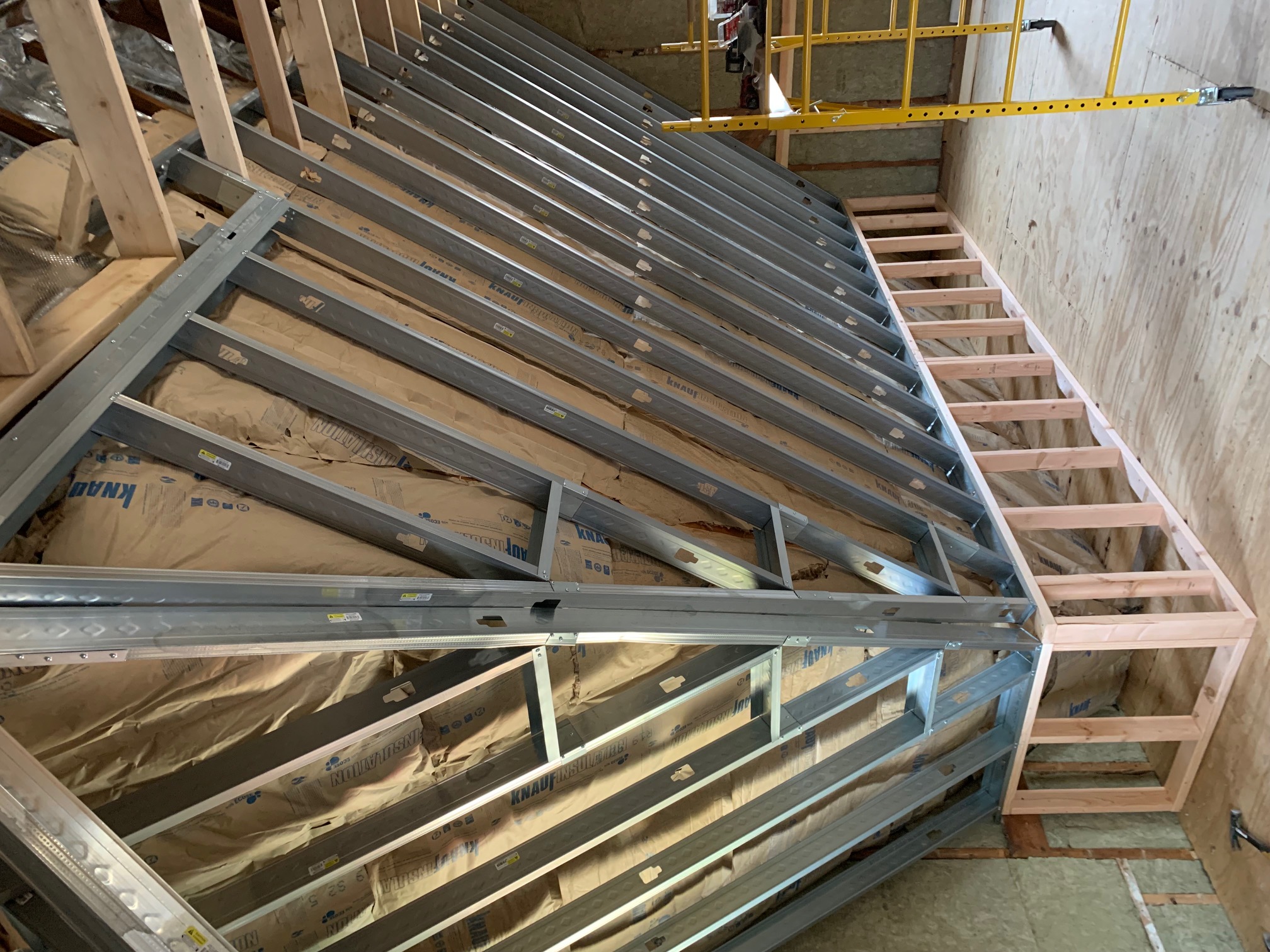 Steel sub-frame and insulation layers